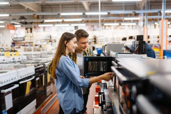 Couple choosing microwave in electronics store